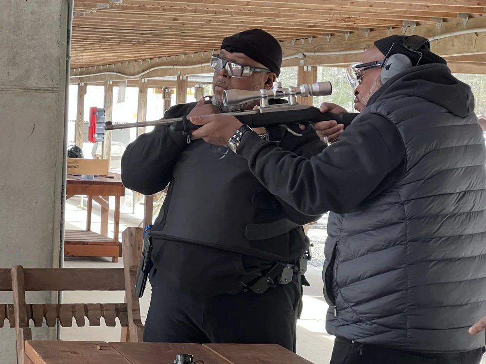 Damon Wright giving a student individual coaching at an outdoor range